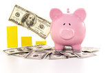 Pink piggy bank beside graph on dollars