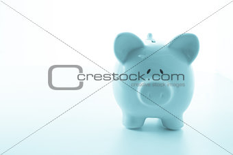 Ceramic blue piggy bank with copy space