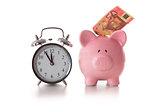 Alarm clock and piggy bank with fifty euro sticking out
