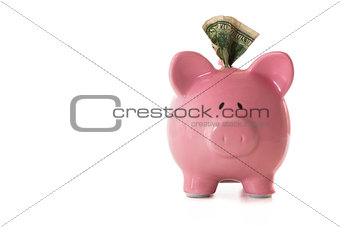 Dollar note sticking out of piggy bank