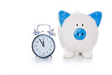 Hand painted blue and white piggy bank beside alarm clock
