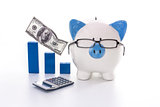 Blue and white piggy bank wearing glasses with blue graph model and calculator