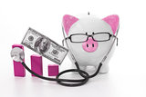 Pink and white piggy bank wearing glasses and stethoscope