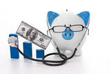 Blue and white piggy bank wearing glasses and stethoscope