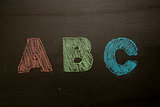 Abc drawn and coloured in on blackboard