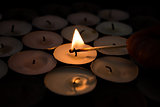 Match lighting tea light candle