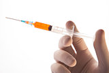 Gloved hand holding hypodermic needle