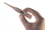 Gloved hand holding digital thermometer
