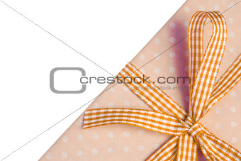 Yellow gift wrapped present with gingham ribbon