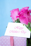 Bouquet of pink roses with pink gift and blank card