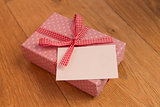 Pink wrapped present with blank card