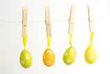 Four easter eggs hanging from a line