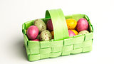 Speckled colourful easter eggs in a green basket