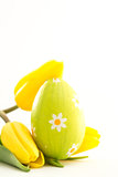 Green easter egg with yellow tulips