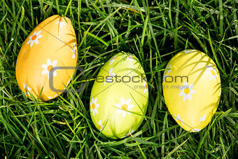 Three easter eggs nestled in the grass