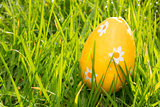 Orange easter egg in the grass