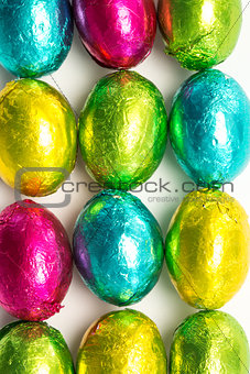 Colourful foil wrapped easter eggs overhead shot