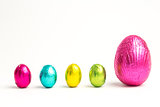 Four small easter eggs beside large one