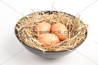 Three eggs in a black bowl