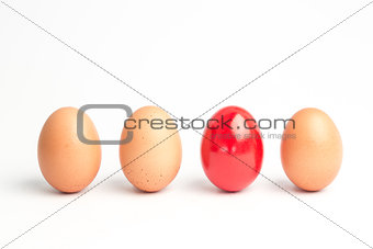 Four eggs in a row with one red one