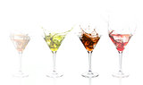 Serial arrangement of coloured alcohol splashing in cocktail glass