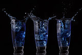 Serial arrangement of blue liquid splashing in glass