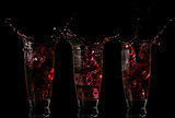 Serial arrangement of red liquid splashing in glass