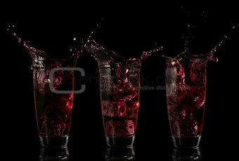 Serial arrangement of red liquid splashing in glass