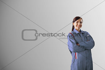 Mechanic standing in front of a grey background