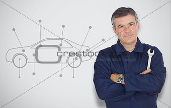 Mature mechanic standing next to car diagram