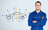 Portrait of a young mechanic next to background with car