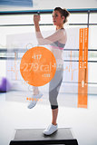 Woman doing exercise with futuristic interface showing calories