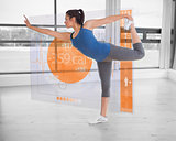 Brunette in yoga pose with futuristic interface next to her