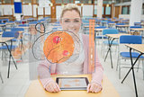 Front view of a student with a tablet looking at futuristic interface