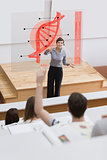 Teacher in front of futuristic interface pointing college student