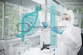Chemist working cautiously with blue liquid and futuristic interface with dna diagram