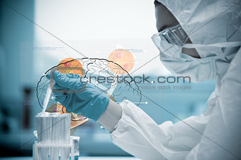 Chemist pouring liquid into test tubes with futuristic interface next to him