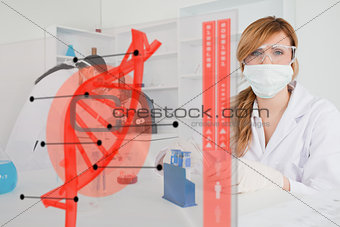 Chemist working in protective suit with futuristic interface in front of her
