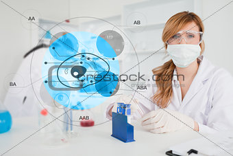 Scientist with protective mask using cell diagram interface