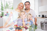 Happy family using futuristic interface to prepare dinner