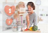 Cute couple making dinner using interface instructions