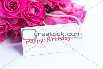 Close up of a beautiful bouquet of roses with a happy birthday card