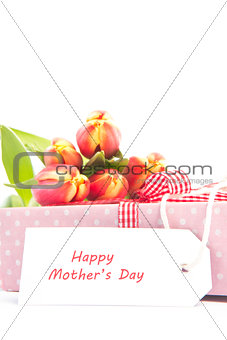 Bouquet of tulips on a gift with a happy mothers card