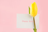 Yellow tulip with a Happy Easter card written in pink