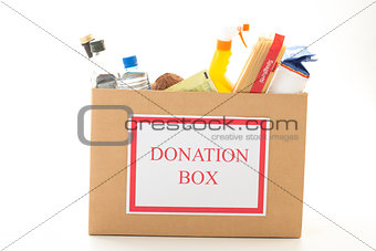 Cardboard donation box with houseware product and food