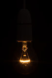 Close up of bright light bulb in the dark