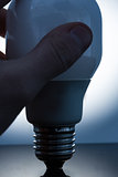 Hand holding an economic light bulb
