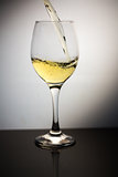 White wine being poured into clear wine glass