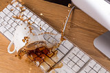 Cup of tea spilled over a keyboard