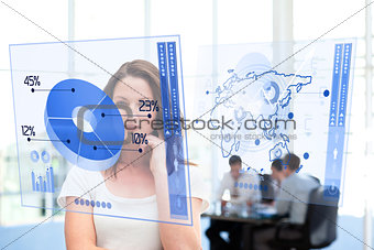 Smiling businesswoman looking at blue pie chart interface